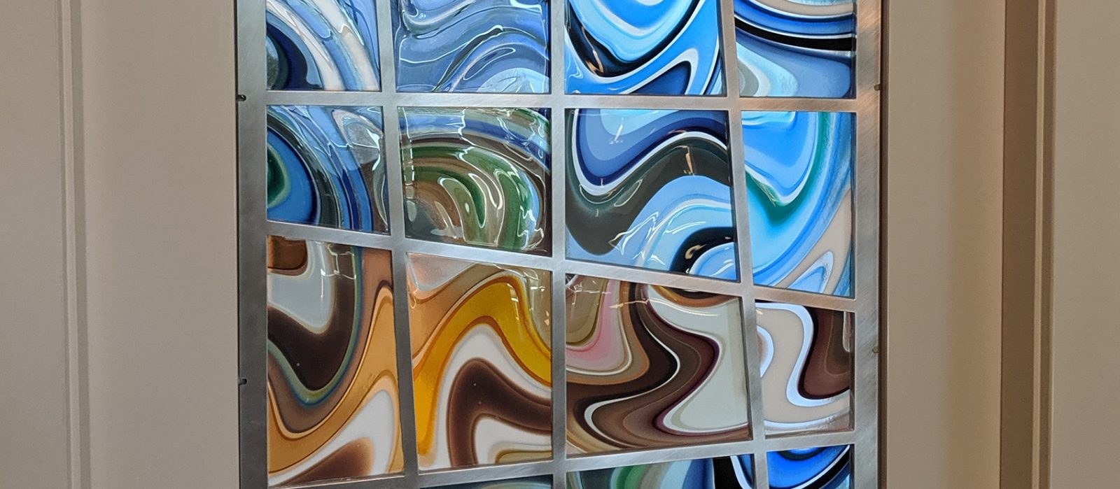 Amazing pocket door, made with striped blown glass panels set in metal